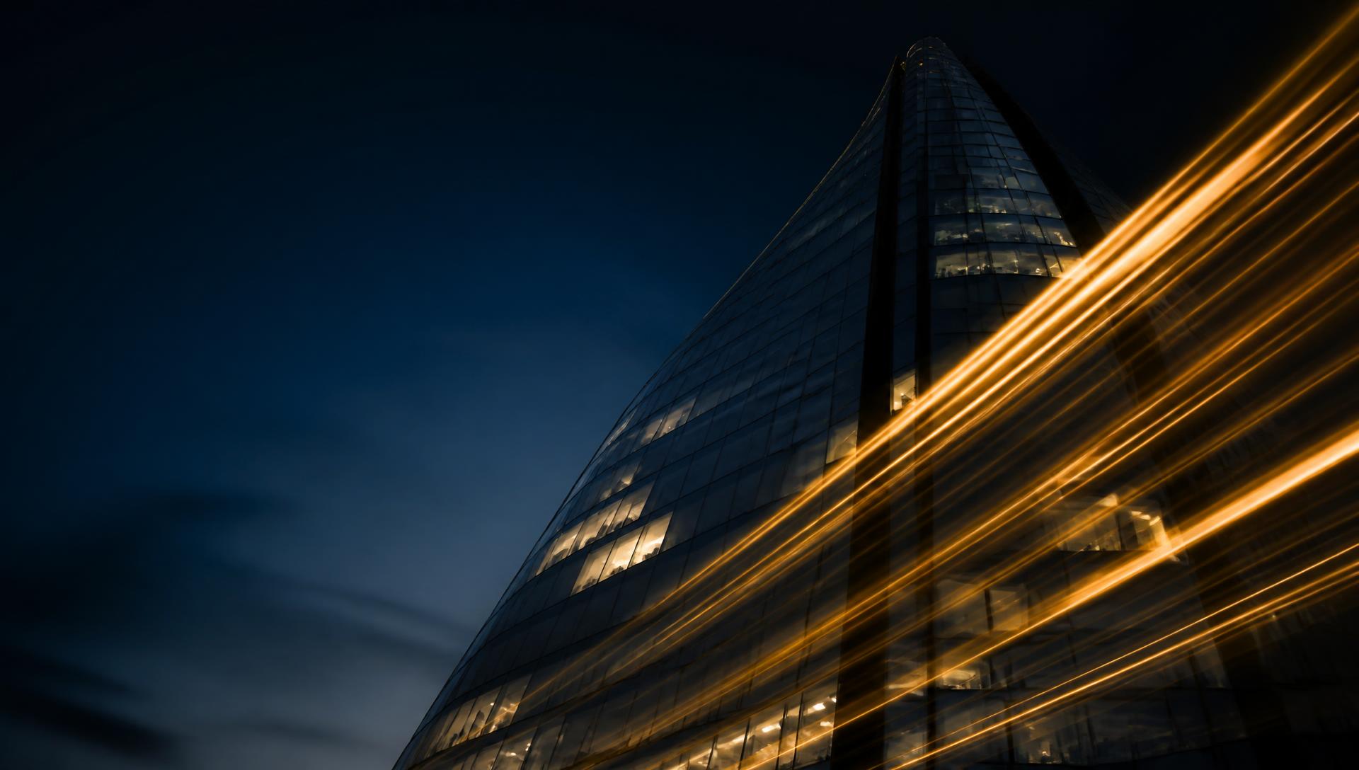 London skyline at dusk with golden light trails