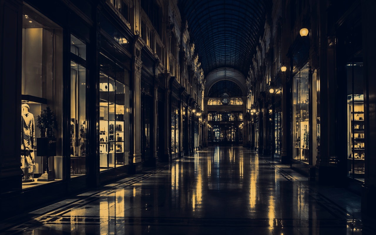 Illuminated retail arcade at night