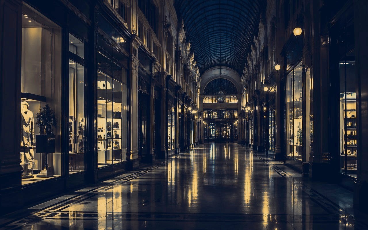 Illuminated retail arcade at night